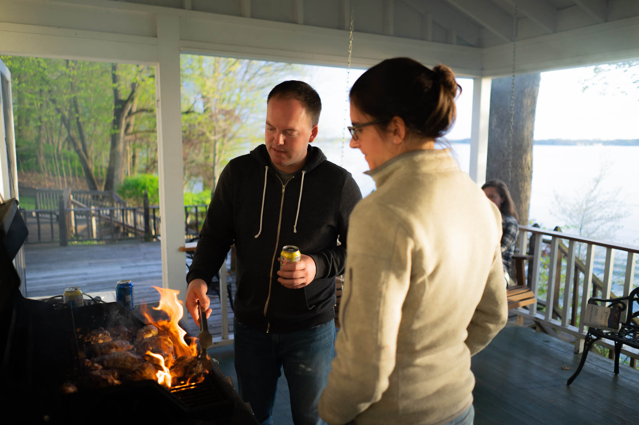 Kevin Lawler and Maria Gibbs grilling (and burning) chicken on the original front porch.