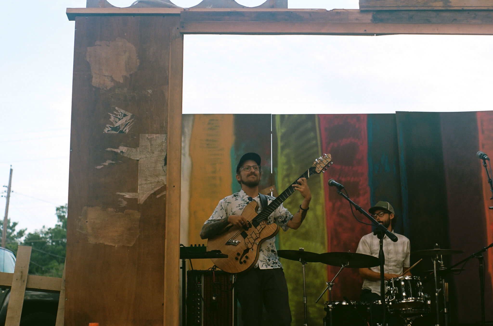 Eli Kahn performing with Tom Nania and Arthur Schroeder as AIRIAR inside the TV set built by Lauren Steinhofer and Jay Jeffcoat.