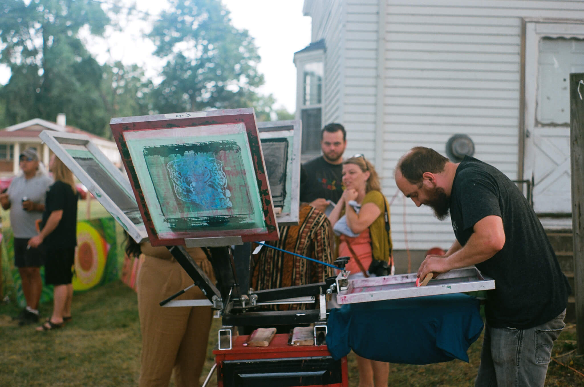 Bradley Davenport, artistic director of Mosaic Studios &amp; Gallery, screen prints custom (Y)ART? tees.