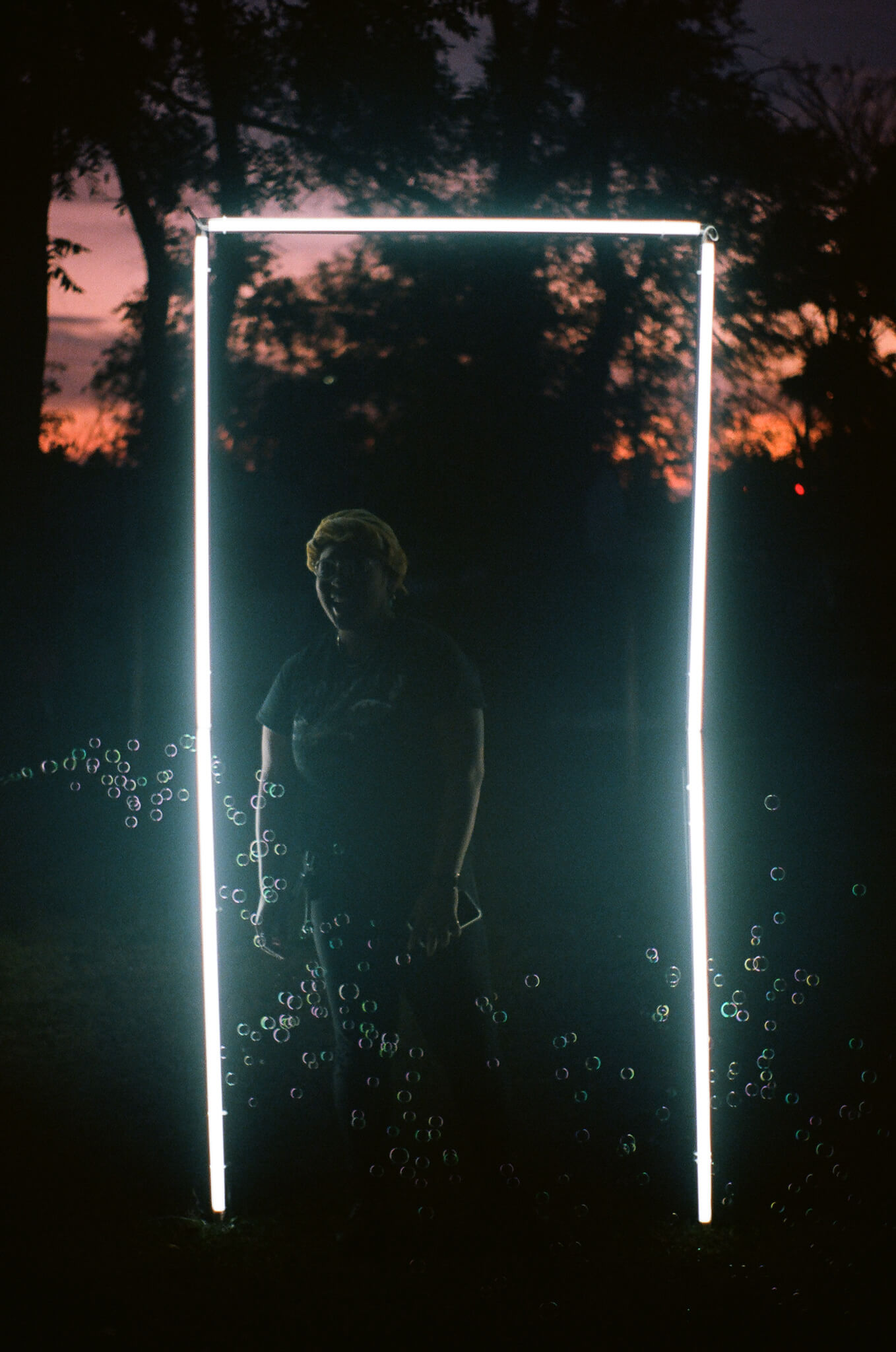 GIIIVENS inside their light sculpture.