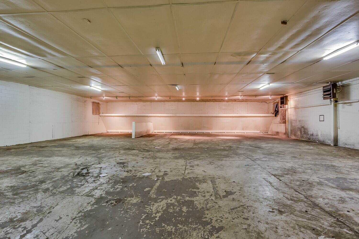 The Armory’s shooting range and vehicle storage, now the wine bar, before restoration.